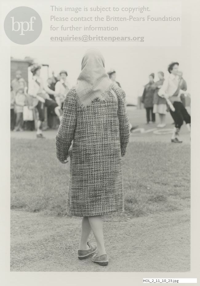 Photograph of Imogen Holst watching dancers on the seafront