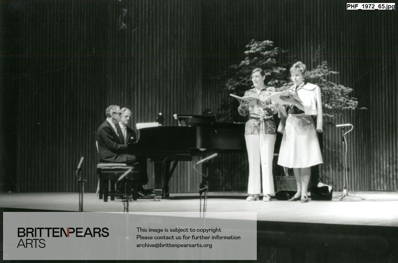 Photograph of Benjamin Britten at the piano with Peter Pears, with Meriel Dickinson and Felicity Palmer singing
