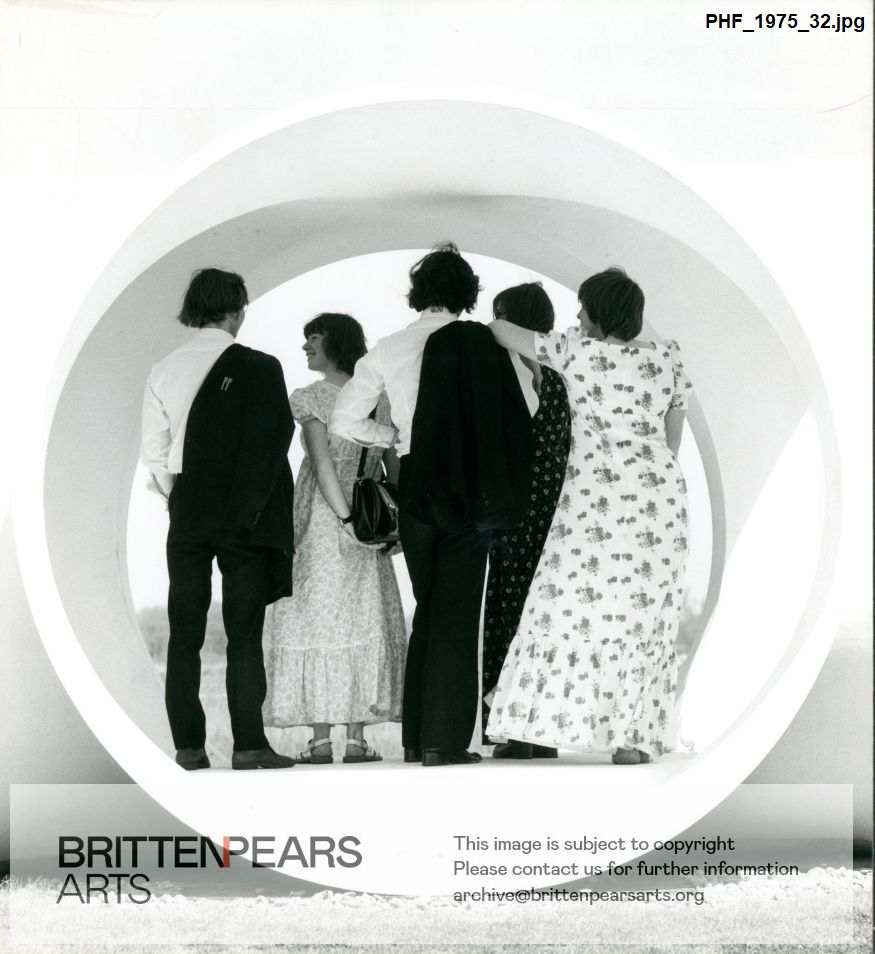 Photograph of five people standing in Wendy Taylor's sculpture Gazebo at Snape Maltings
