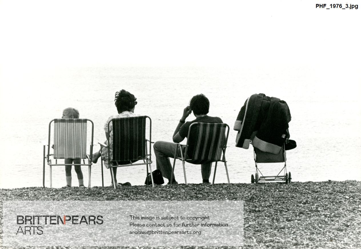 Photograph of two adults and a child on beach at Aldeburgh