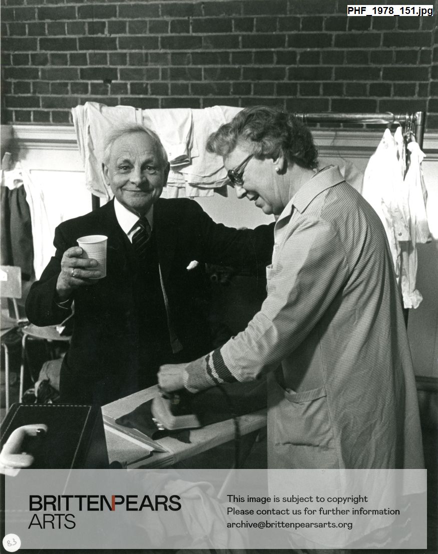 Photograph of James Blades smiling and Sue Iles ironing