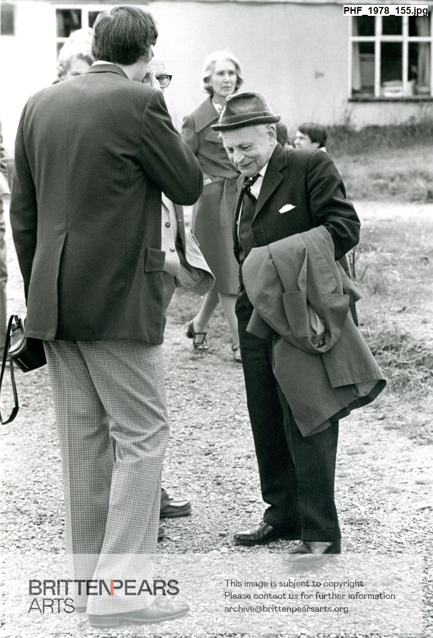 Photograph of James Blades talking with undentified people