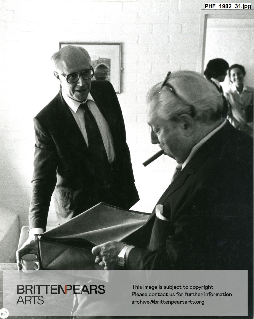 Photograph of Mstislav Rostropovich talking with Isaac Stern backstage