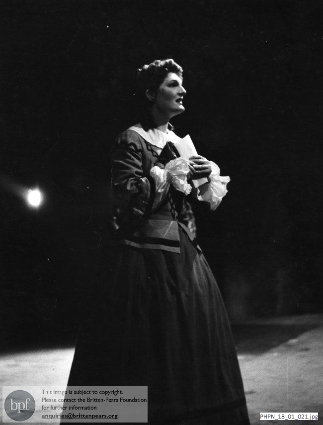 Production photograph of The Turn of the Screw: Jennifer Vyvyan in the Governess's travelling costume