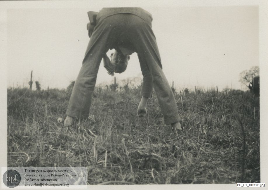 Benjamin Britten fooling in a field