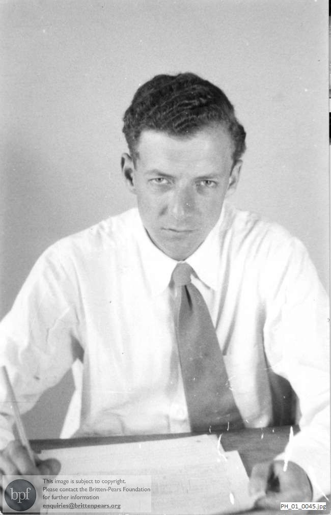Benjamin Britten writing at a table