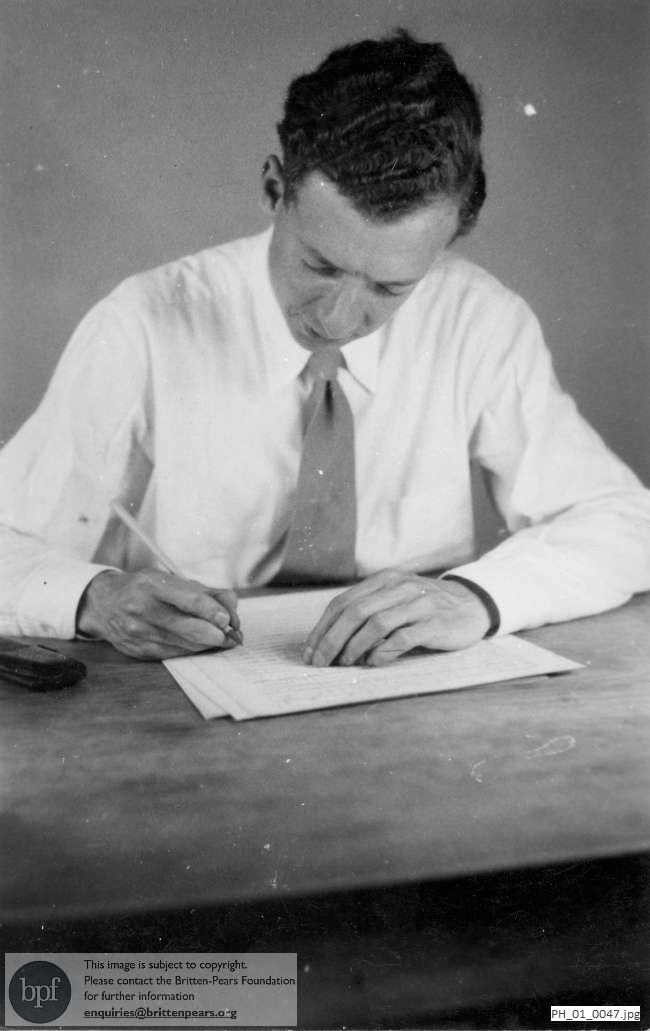 Benjamin Britten working at a table
