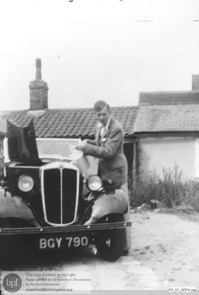 Benjamin Britten with his car at the Old Mill, Snape