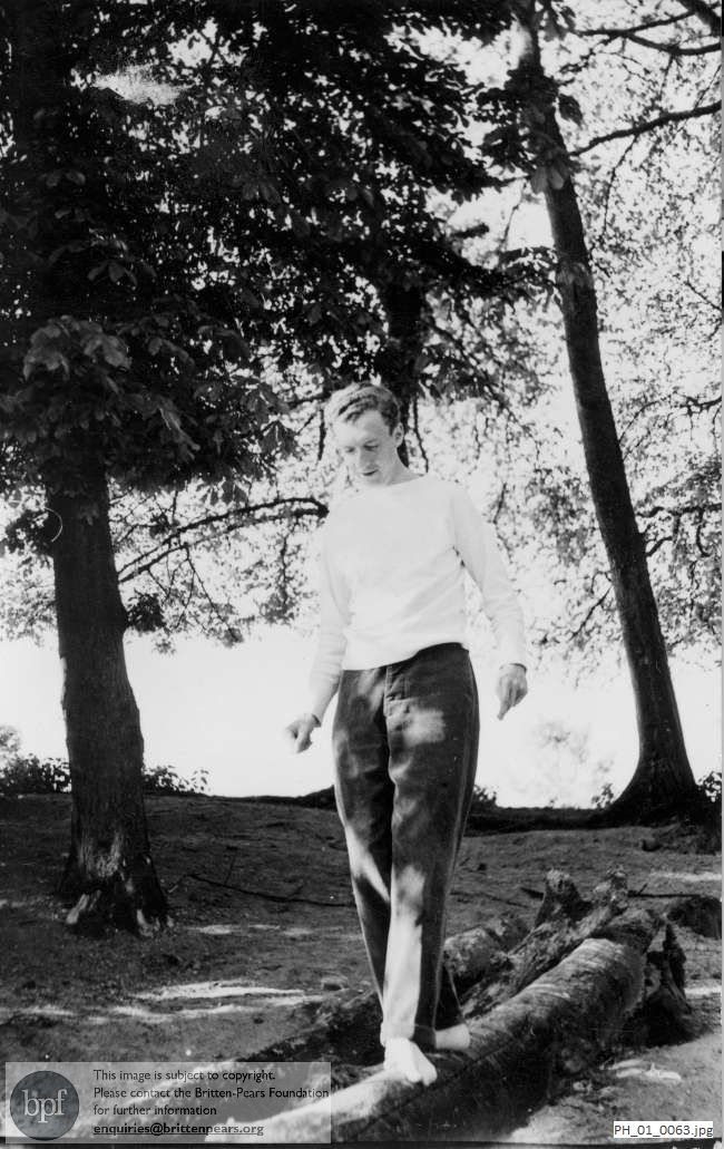Benjamin Britten walking on a log