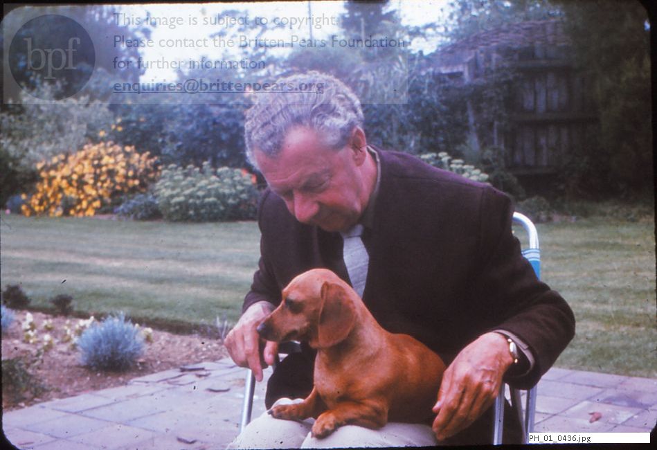 Benjamin Britten in the Red House garden with his dachshund dog