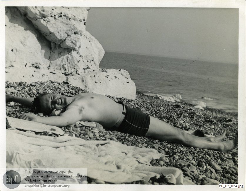 Peter Pears lying on a beach in America