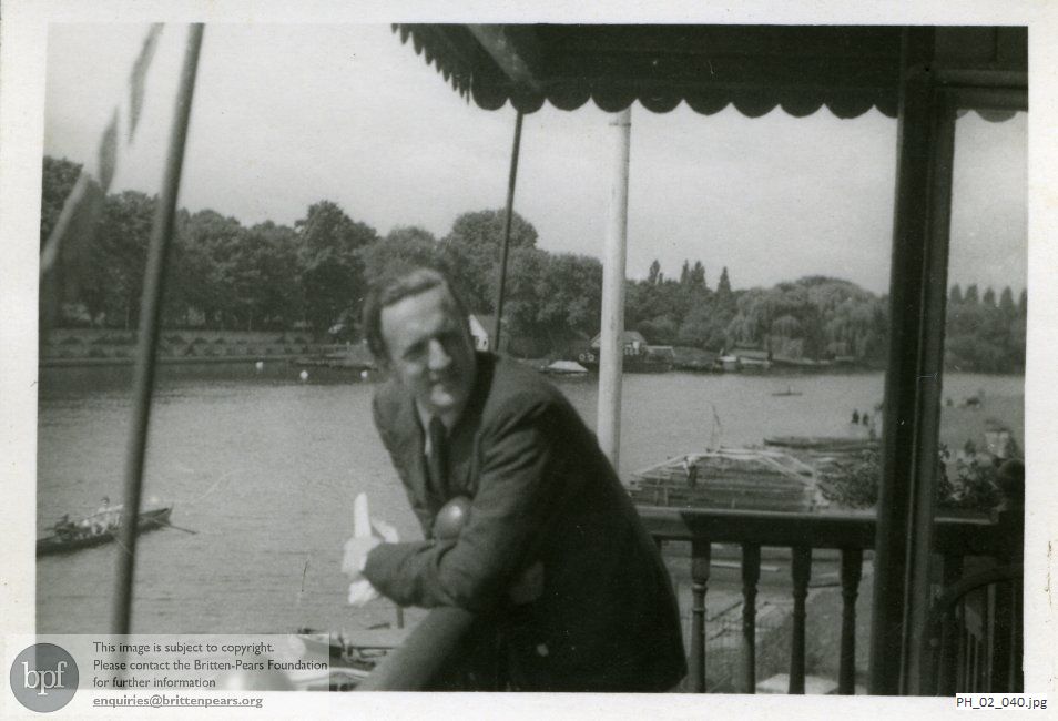 Peter Pears on a riverside balcony