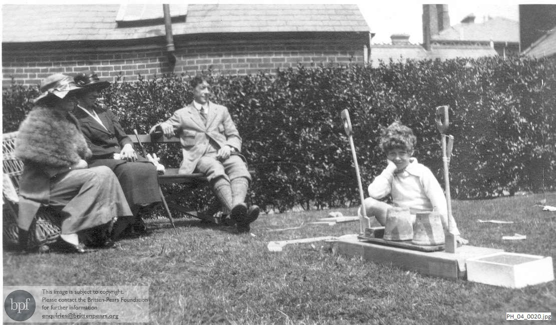 Benjamin Britten in the garden at home with his parents and god-parent 