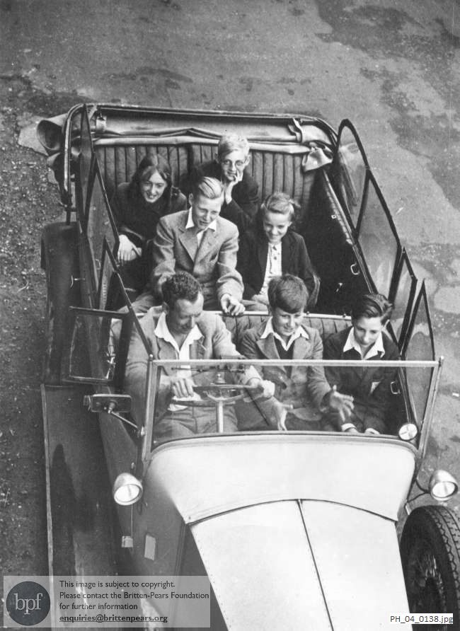 Benjamin Britten in his car with the children of the original cast of Let's Make an Opera