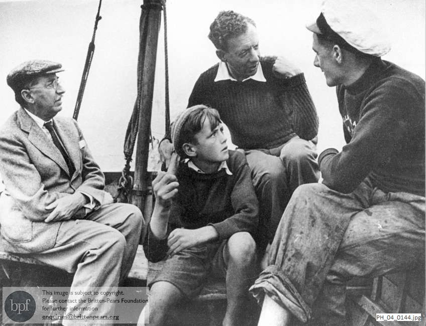 Benjamin Britten and friends seated in the stern of a boat