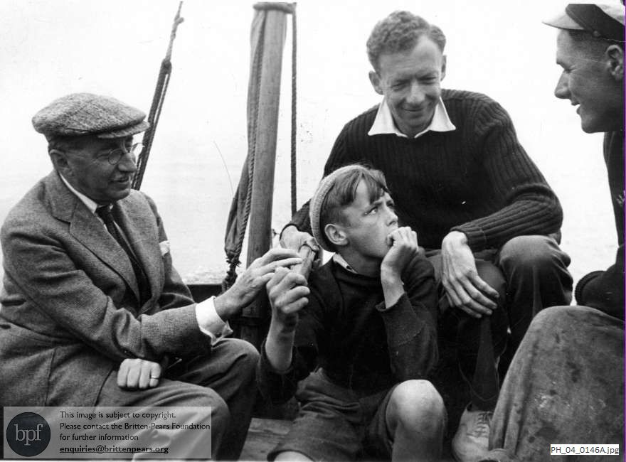 Benjamin Britten and friends seated in the stern of a boat