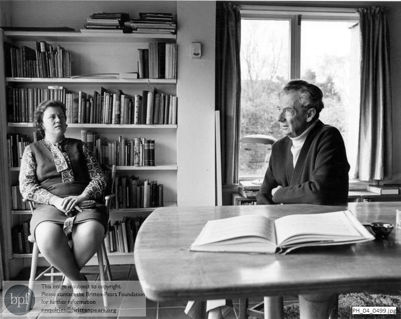 Benjamin Britten seated with Rita Thomson in the Library at the Red House, Aldeburgh