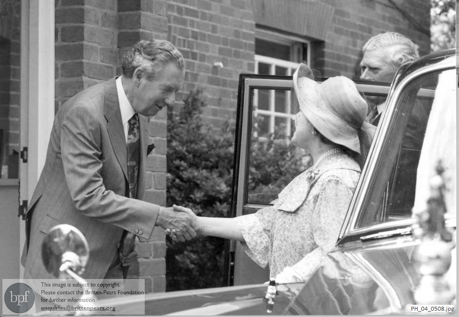 Benjamin Britten shakes the Queen Mother's hand as she arrives at the Red House, Aldeburgh