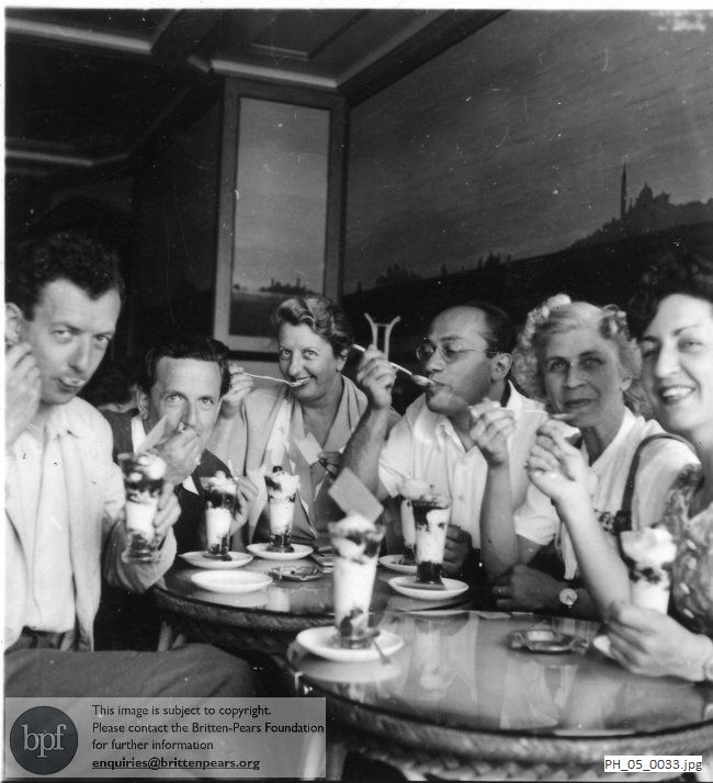 Benjamin Britten and Peter Pears eating ice creams with members of the cast of 'The Rape of Lucretia'