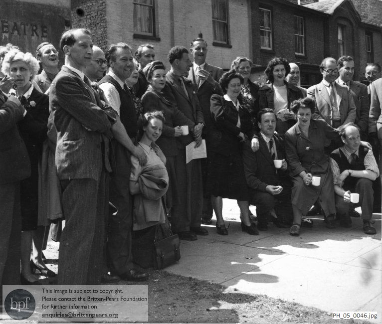 Benjamin Britten and Peter Pears with the English Opera Group outside the Arts Theatre, Cambridge