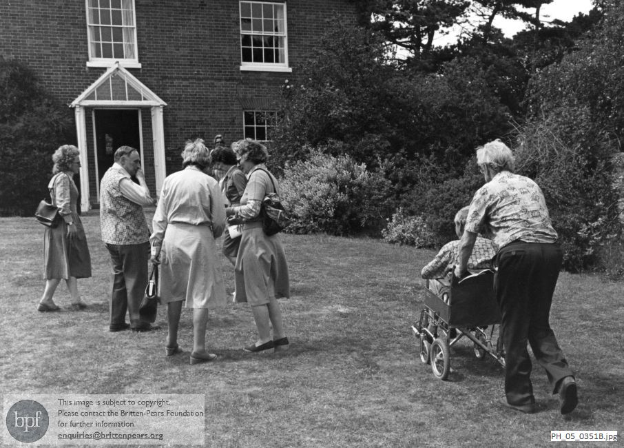 Benjamin Britten and Peter Pears with garden party guests at The Red House, Aldeburgh